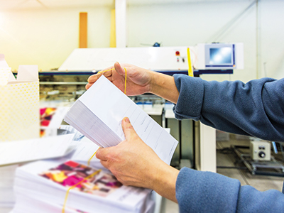 Mitarbeiter sortiert Mailings nach Seriendruck | Mail Boxes Etc.
