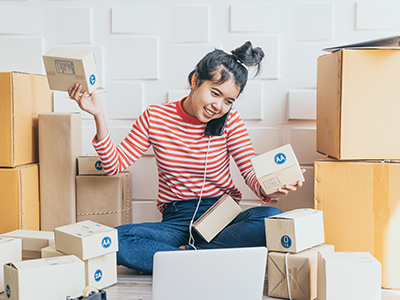 Girl Plays E-Commerce Between Shipping Boxes | Mail Boxes Etc.